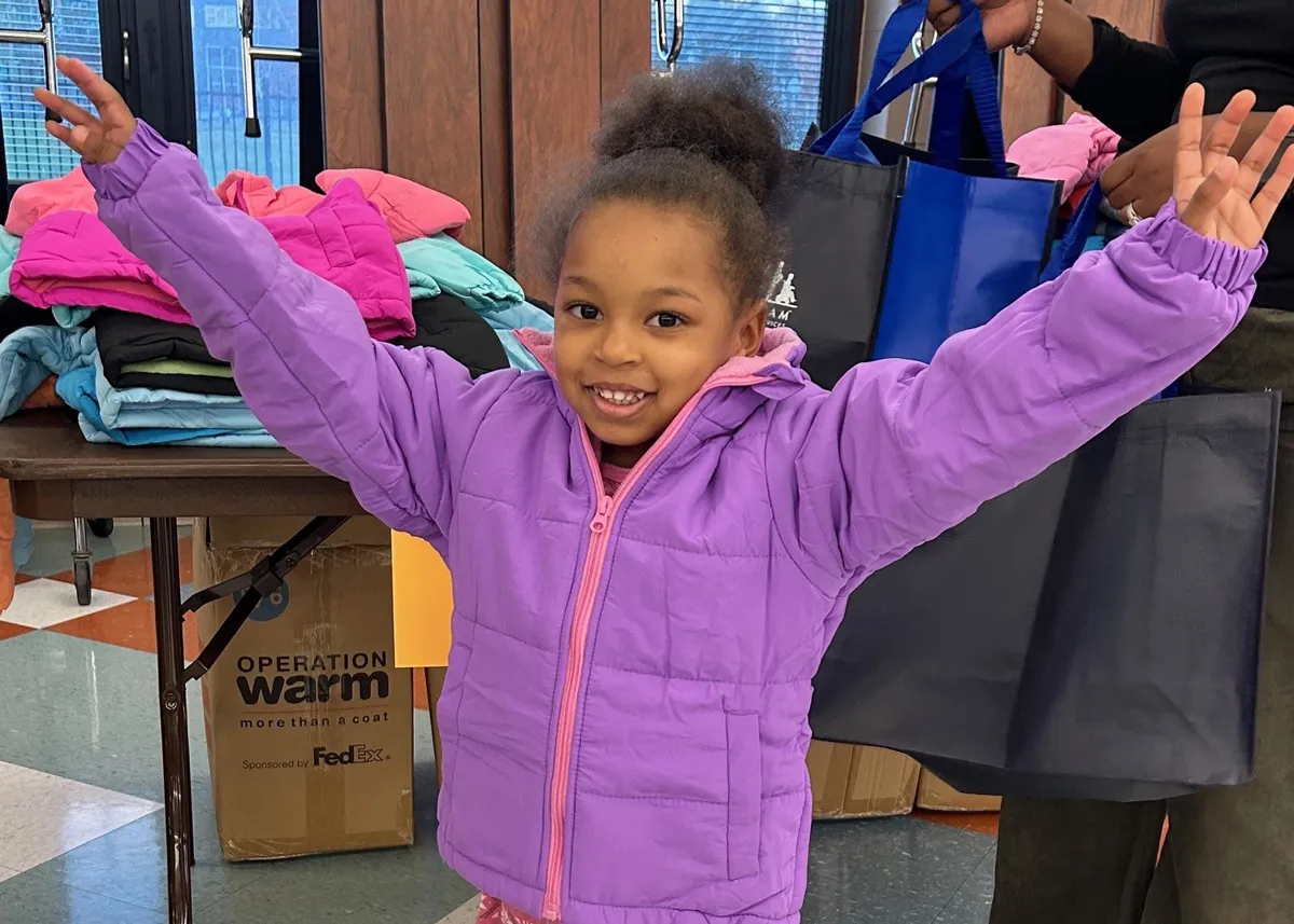 kid receiving new coat