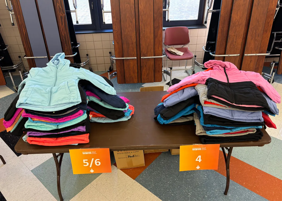 coats on table for charity event