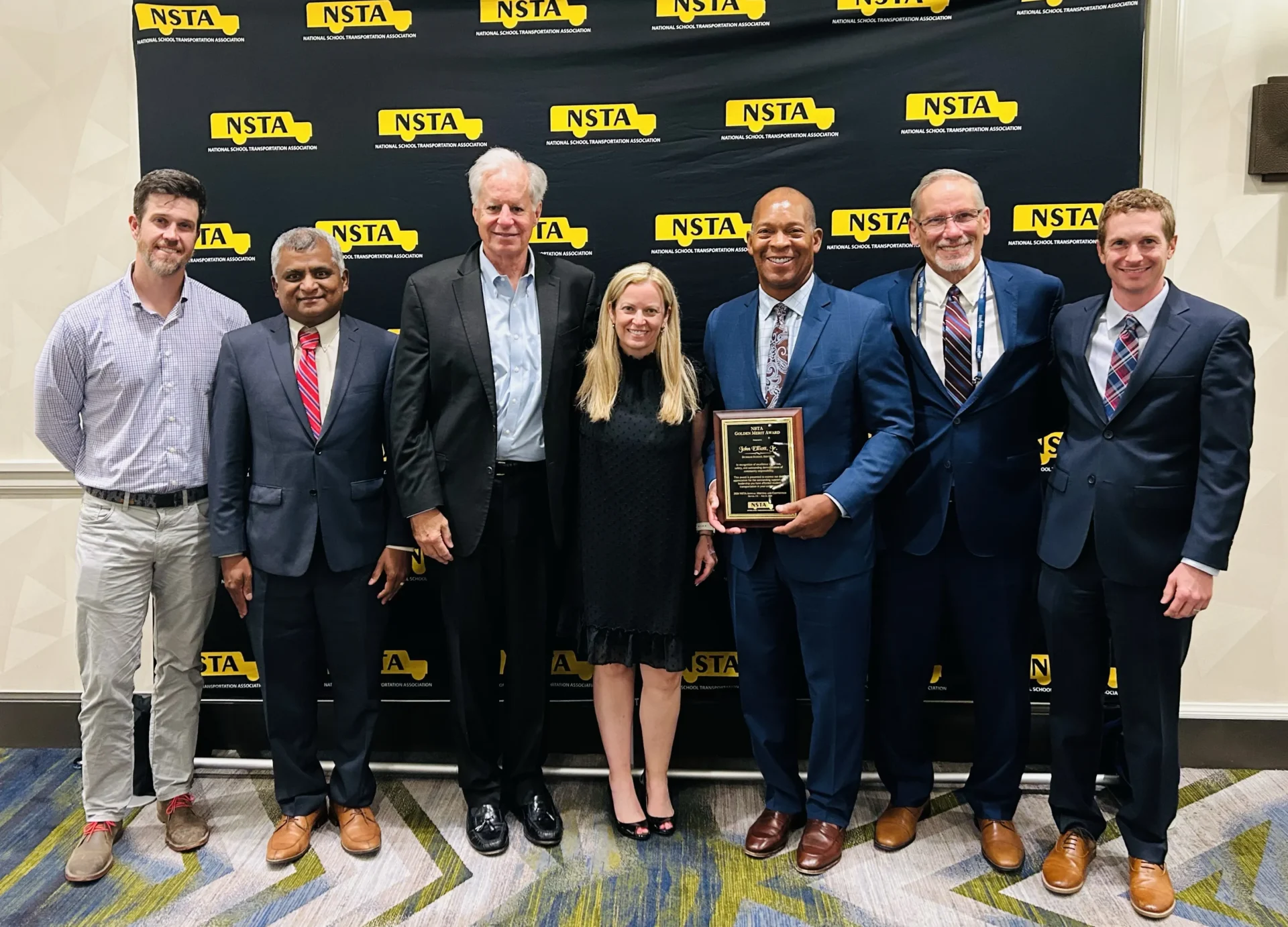 Stewart Gabb, Keshav Ragunathan, Paul Osland, Carina Noble, John Elliott Jr., John Ziegler, and Dan Cecchin celebrating John Elliott Jr.’s achievement.